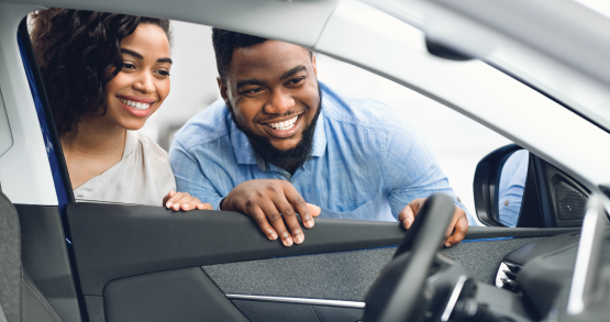 two people looking into a car window