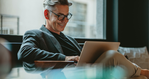 a guy looking at his ANBTX business account on his laptop