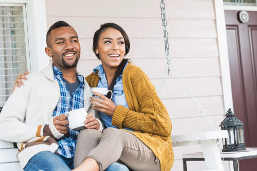 a couple drinking coffee on their patio