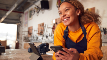 Woman smiling with phone in hand