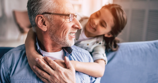 a grandpa and his grandchild talking about a Youth Savings account at ANBTX