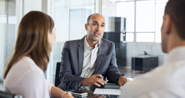 a company talking to an ANBTX employee about business loans and lines of credit