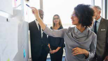 a woman looking at a white board