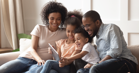 a family looking at new houses on a tablet