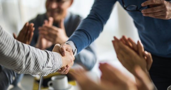 a group of people talking and shaking hands