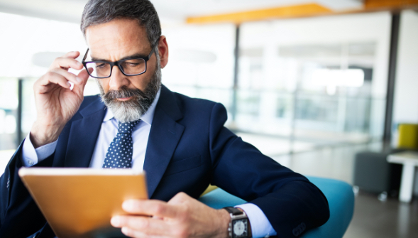 man looking at tablet