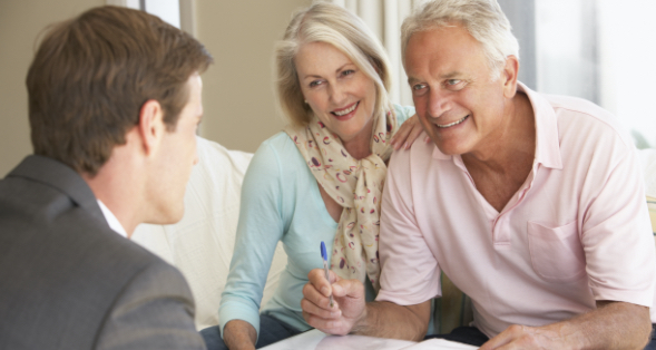 middle-aged couple discussing retirement with advisor