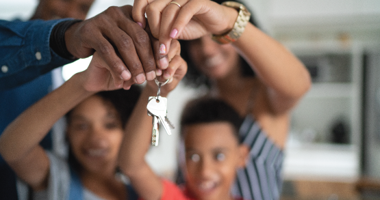 a family getting keys to their new house after getting a mortgage though ANBTX